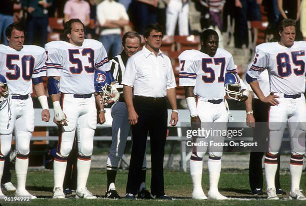 Head Coach Dan Reeves of the Denver Broncos stands in the middle of his players Tom Jackson, Randy Gradishar, Jim Ryan and Ron Egloff for the...