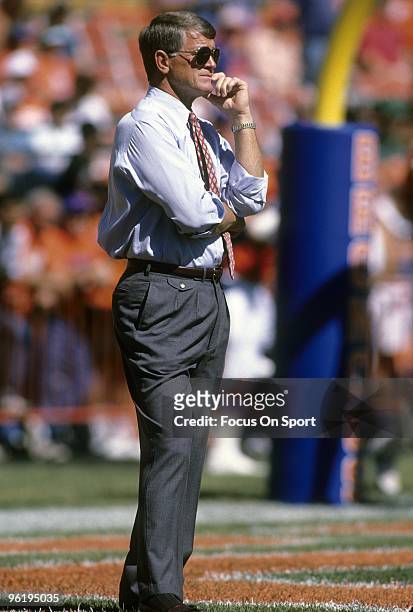 S: Head Coach Dan Reeves of the Denver Broncos on the field watching his team warm-up prior to the start of a mid circa 1980's NFL football game at...