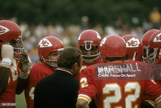 S: Head Coach Hank Stram of the Kansas City Chiefs talks with several of his players on the field during a late circa 1960's NFL football game at...