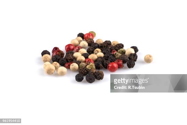 heap of various pepper peppercorns seeds mix on white - red peppercorns stock pictures, royalty-free photos & images