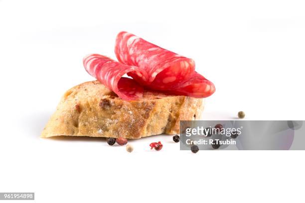 salami on ciabatta. sandwich of salami slices on whole grain bread. - salami 個照片及圖片檔