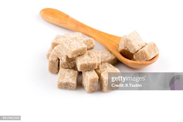brown sugar in a wooden spoon on a white background - hiperglicemia - fotografias e filmes do acervo