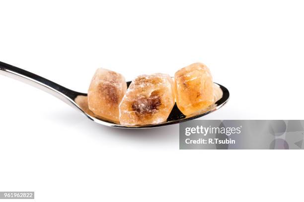 brown caramelized sugar in a wooden spoon on a white background - hyperglycemia stock pictures, royalty-free photos & images