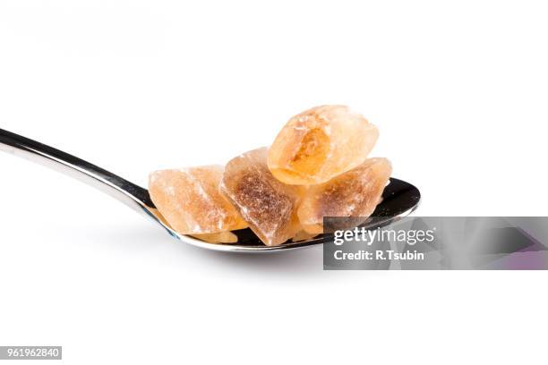 brown caramelized sugar in a wooden spoon on a white background - hyperglycemia stock pictures, royalty-free photos & images