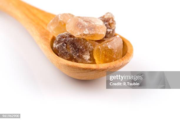 brown caramelized sugar in a wooden spoon on a white background - hyperglycemia stock pictures, royalty-free photos & images