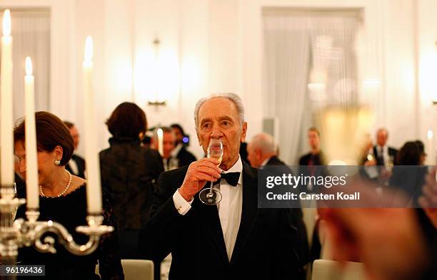 Israeli President Shimon Peres drinks at a gala dinner given by German President Horst Koehler in honour of the Israeli President on January 26, 2010...