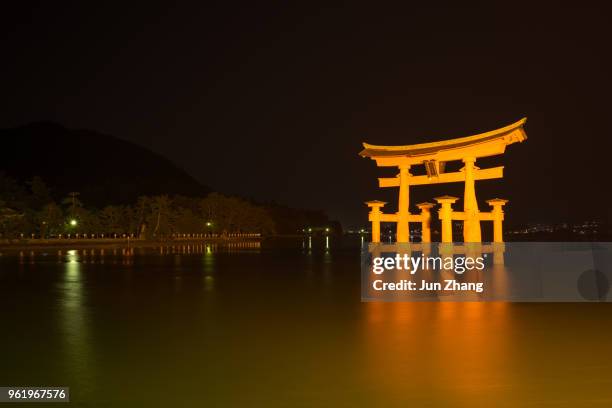 long exposure image of the floating gate torii of itsukushima shrine - torii gate stock pictures, royalty-free photos & images