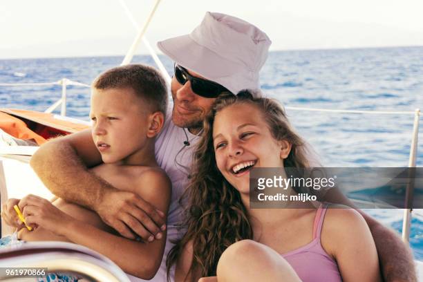 father having a fun with children on sailing - miljko stock pictures, royalty-free photos & images
