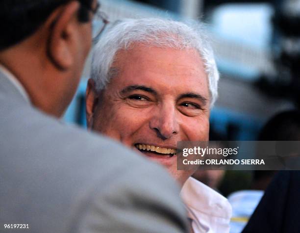 Panamanian President Ricardo Martinelli greets Honduran businessmen upon his arrival in Tegucigalpa, on January 26, 2010. Martinelli is in Honduras...