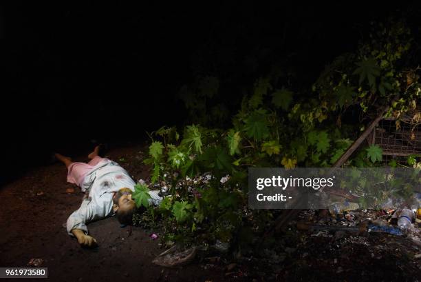 Graphic content / This photo taken on May 18, 2018 shows the dead body of a Bangladeshi alleged drug dealer after a gun battle with law enforcement...