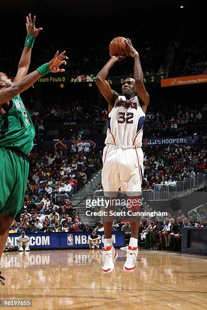 Joe Smith of the Atlanta Hawks shoots a jump shot against Shelden Williams of the Boston Celtics during the game at Philips Arena on January 8, 2010...