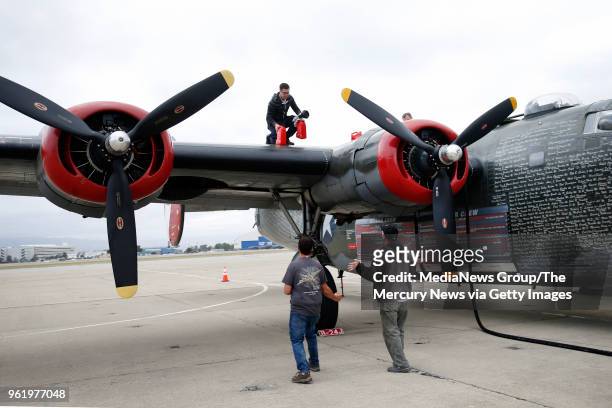 Jeff Fink adds 120W oil to the Consolidated B-24 Liberator, "Witchcraft", part of the Wings of Freedom Tour visiting Moffett Field in Mountain View,...