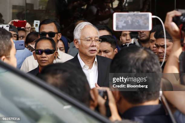 Najib Razak, Malaysia's former prime minister, center, speaks to members of the media as he leaves the Malaysian Anti-Corruption Commission...