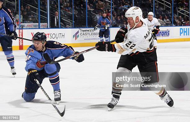 Todd Marchant of the Anaheim Ducks fires a shot as he is defended by Maxim Afinogenov of the Atlanta Thrashers at Philips Arena on January 26, 2010...