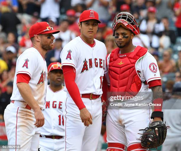 Zack Cozart and Martin Maldonado looks on as pitcher Shohei Ohtani of the Los Angeles Angels of Anaheim waits on the mound to be pulled from the...