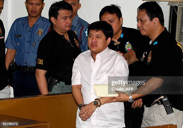 National Burueau Investigation agents escort Datu Unsay Mayor Andal Ampatuan Jr., the prime suspect in the country's worst political massacre, inside...