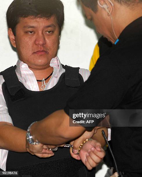 Datu Unsay Mayor Andal Ampatuan Jr., prime suspect in a massacre of 57 people, is placed in handcuffs as he is escorted by National Bureau of...