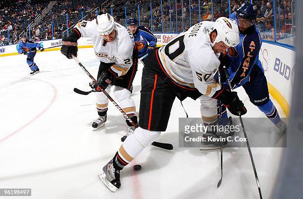 Evander Kane of the Atlanta Thrashers battles for the puck against Kyle Chipchura and Troy Bodie of the Anaheim Ducks at Philips Arena on January 26,...