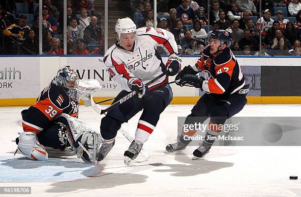 Alexander Semin of the Washington Capitals is stopped in the third period by Rick DiPietro and Andrew MacDonald of the New York Islanders on January...