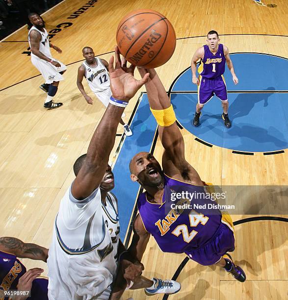 Kobe Bryant of the Los Angeles Lakers rebounds against Antawn Jamison of the Washington Wizards at the Verizon Center on January 26, 2010 in...