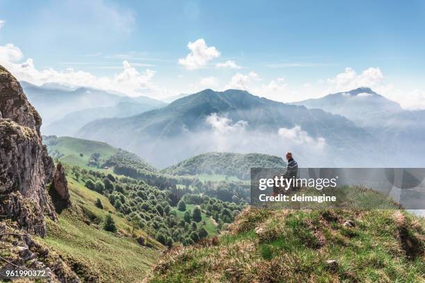man taking mindfullness on the mountains - bergamo stock pictures, royalty-free photos & images