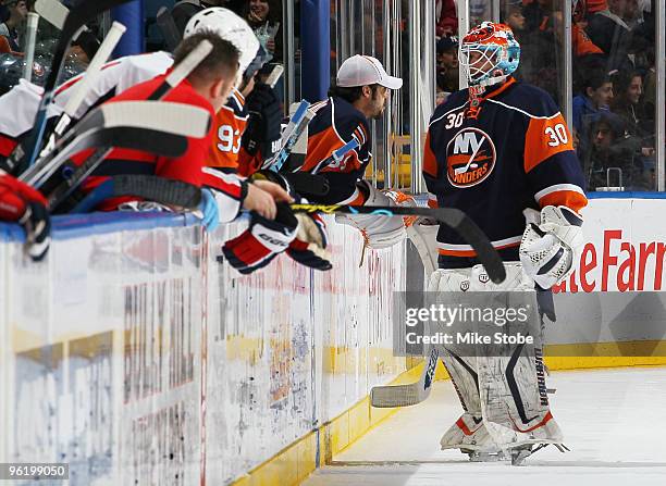 Goaltender Dwayne Roloson of the New York Islanders speaks with teammate Rick DiPietro during a timeout against the Washington Capitals on January...