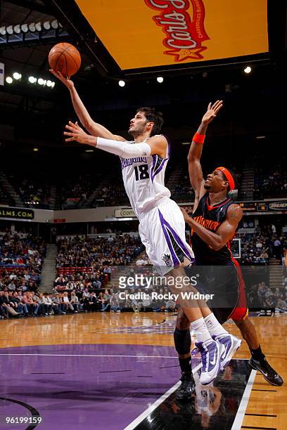 Omri Casspi of the Sacramento Kings gets to the basket against Cartier Martin of the Golden State Warriors on January 26, 2010 at ARCO Arena in...