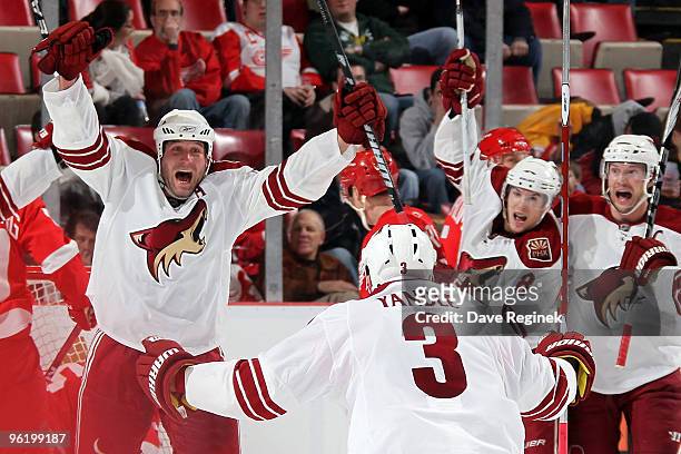 Ed Jovanovski of the Phoenix Coyotes scores the game-tying goal against the Detroit Red Wings and celebrates with teammates Keith Yandle, Scottie...
