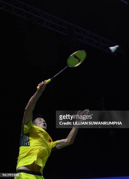 Chen Long of China hits a return against Chou Tien Chen of Taiwan during their men's singles quarterfinals match at the Thomas and Uber Cup in...