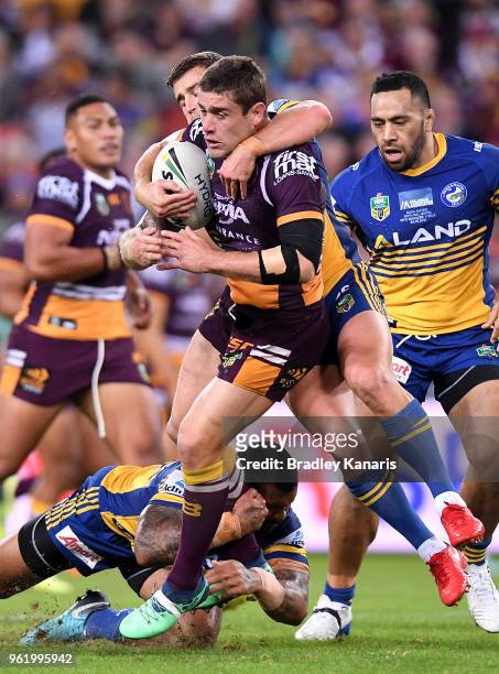 Andrew McCullough of the Broncos is tackled during the round 12 NRL match between the Brisbane Broncos and the Parramatta Eels at Suncorp Stadium on...