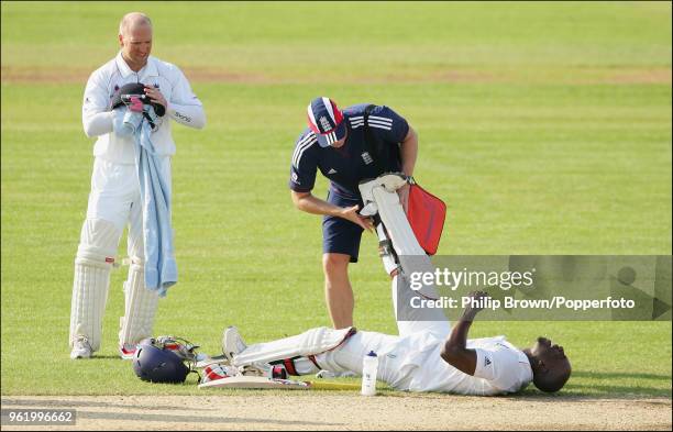 Michael Carberry of England Lions receives treatment for cramp after reaching his century during the tour match between England Lions and New Zealand...