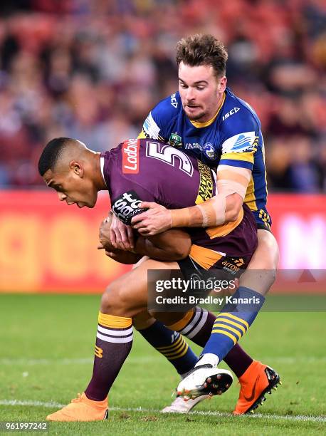 Jamayne Isaako of the Broncos is tackled by Clint Gutherson of the Eels during the round 12 NRL match between the Brisbane Broncos and the Parramatta...