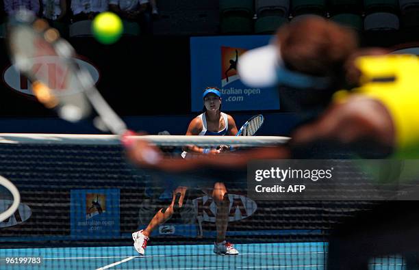 Venus Williams of the US hits a return to Li Na of China in their women's singles quarter-final match on day 10 of the Australian Open tennis...