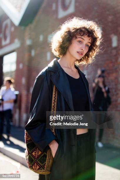 Georgian model Marisha Urushadze wears a black leather jacket and brown bag after the Gucci show during Milan Fashion Week Spring/Summer 2018 on...