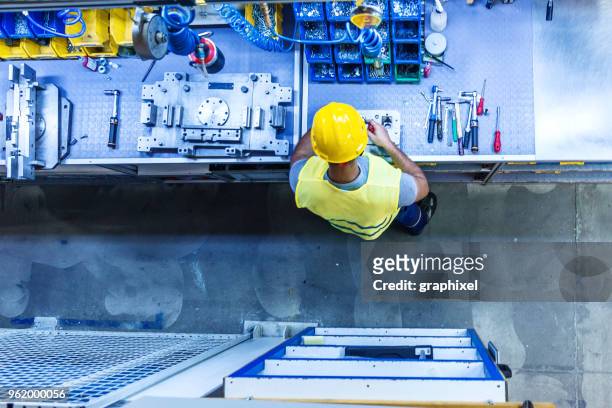 man with tools on industrial workbench - tool rack stock pictures, royalty-free photos & images