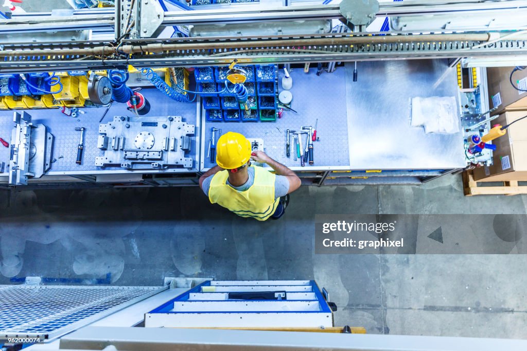 Man with Tools on Industrial Workbench