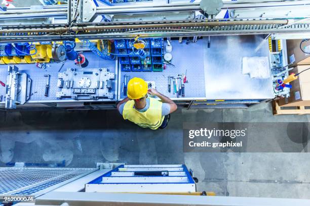 man with tools on industrial workbench - tool rack stock pictures, royalty-free photos & images