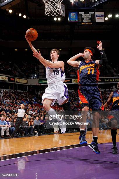 Bano Udrih of the Sacramento Kings gets to the basket against Vladimir Radmanovic of the Golden State Warriors on January 26, 2010 at ARCO Arena in...