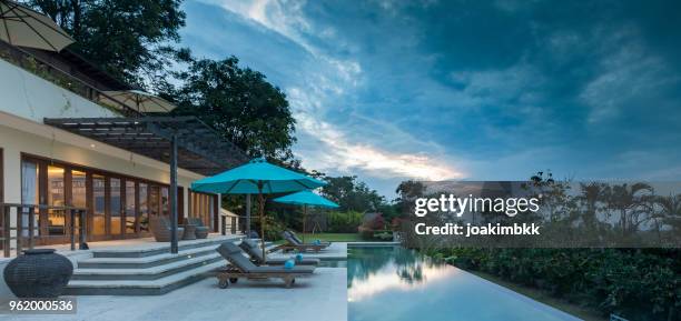 luxurious villa with swimming pool during cloudy sunset in bali - bali luxury stock pictures, royalty-free photos & images