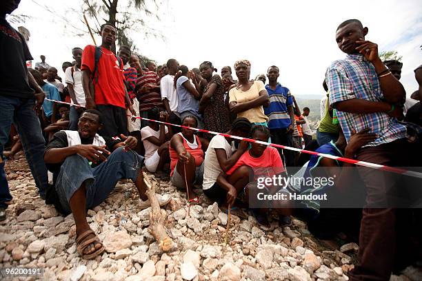 In this handout image provided by the United Nations Stabilization Mission in Haiti , people wait to collect water as the Agency for Technical...