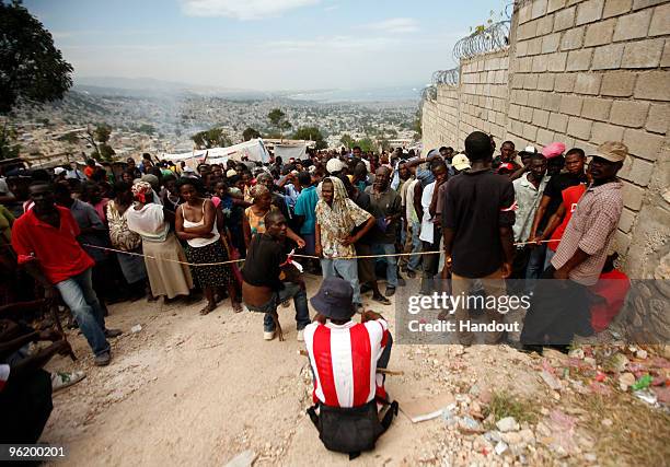 In this handout image provided by the United Nations Stabilization Mission in Haiti , people wait to collect water as the Agency for Technical...