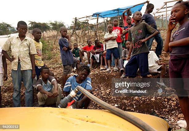 In this handout image provided by the United Nations Stabilization Mission in Haiti , people watch as the Agency for Technical Cooperation and...