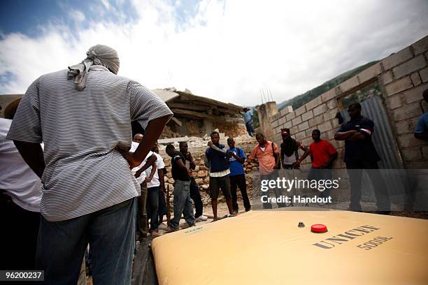 In this handout image provided by the United Nations Stabilization Mission in Haiti , people watch as the Agency for Technical Cooperation and...