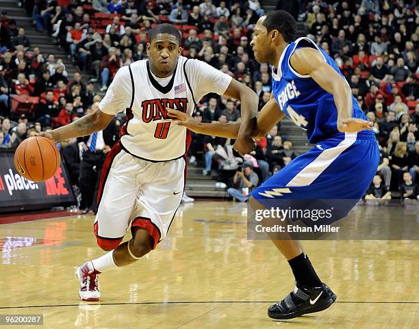 Oscar Bellfield of the UNLV Rebels drives against Derek Brooks of the Air Force Falcons during their game at the Thomas & Mack Center January 26,...