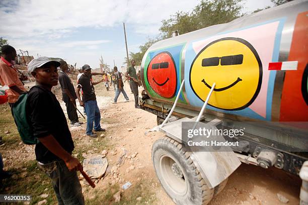 In this handout image provided by the United Nations Stabilization Mission in Haiti , people watch as the Agency for Technical Cooperation and...