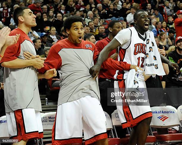 Mychal Martinez, Steve Jones and Brice Massamba of the UNLV Rebels react on the bench to a play by teammate Chace Stanback during their 60-50 victory...