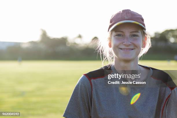 portrait of a female sports player on sports field with the sun behind her - documentaire stockfoto's en -beelden