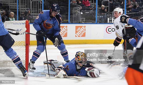 Johan Hedberg and Nik Antropov of the Atlanta Thrashers defend a shot by Bobby Ryan of the Anaheim Ducks at Philips Arena on January 26, 2010 in...