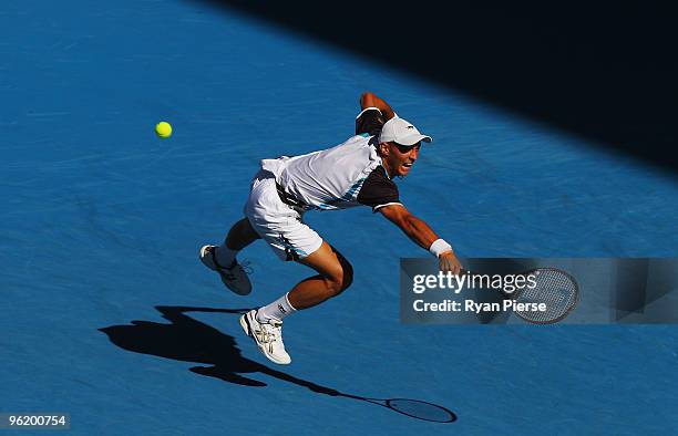 Nikolay Davydenko of Russia plays a backhand in his quarterfinal match against Roger Federer of Switzerland during day ten of the 2010 Australian...