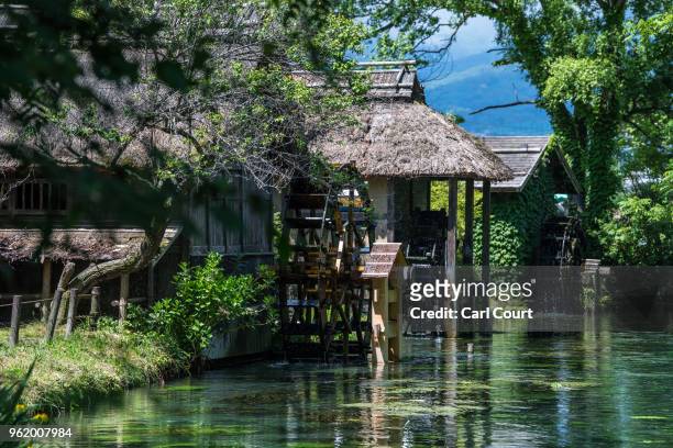 Waterwheel carries spring water from Daio Wasabi Farm into a river on May 24, 2018 in Azumino, Japan. Operating since 1923 in Azumino, one of Japan's...